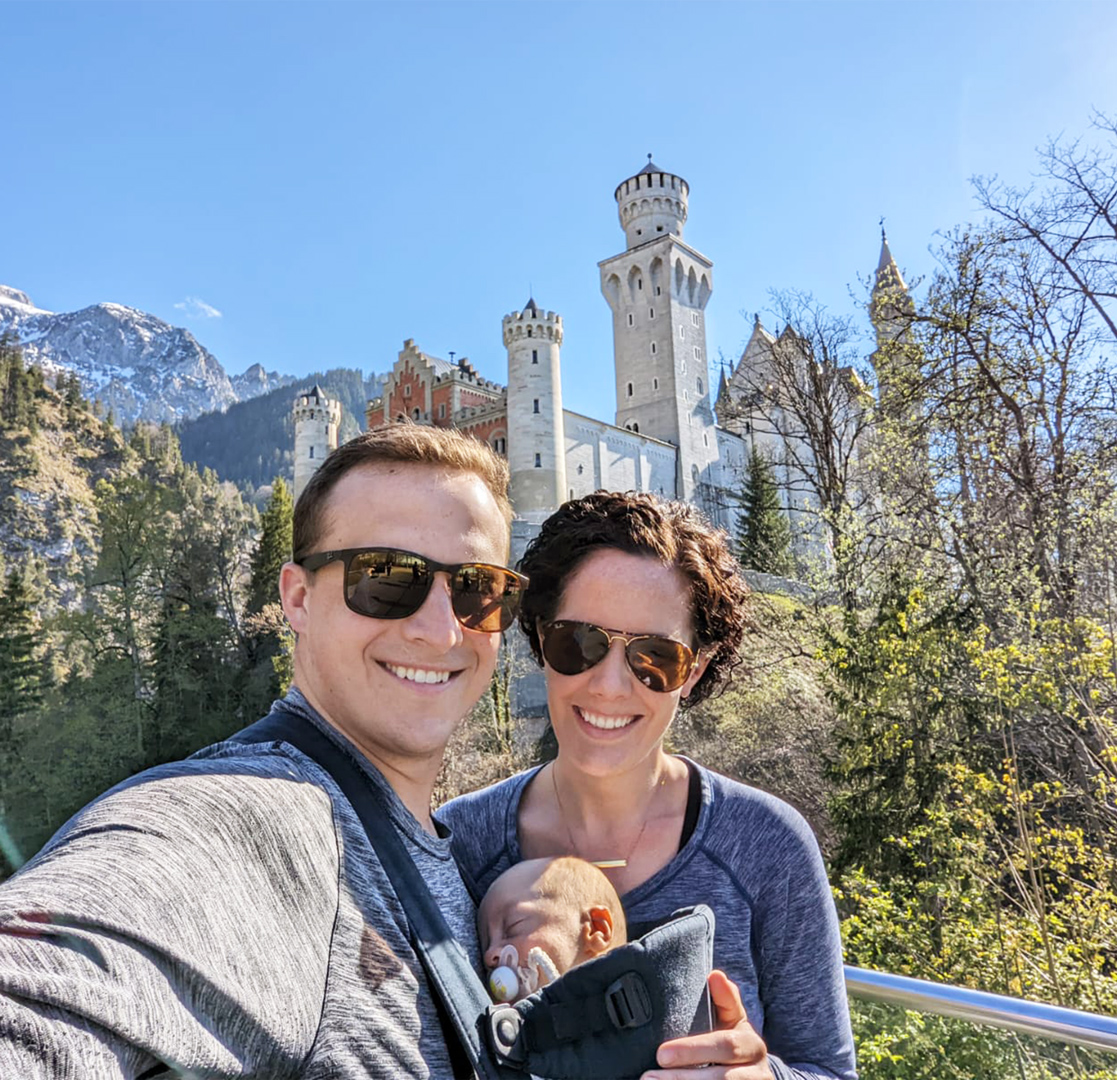 Dr. Jim Cholewa with his wife and baby, posing in front of castle in Des Moines IA