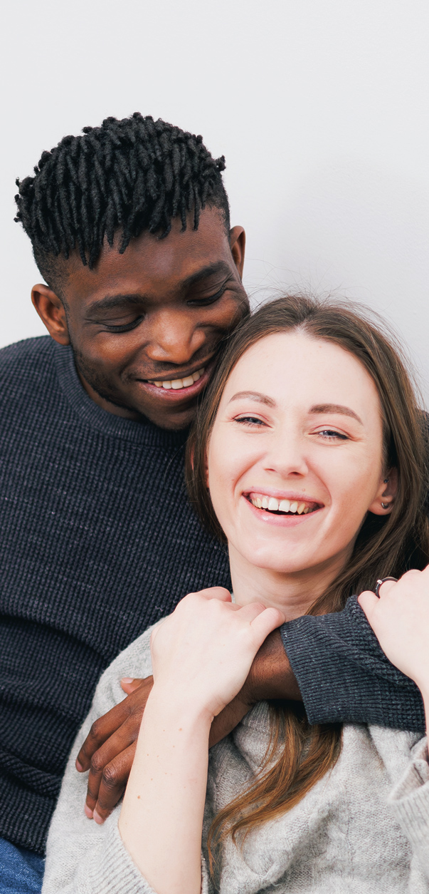 Happy couple embracing and smiling while sitting together in Des Moines IA