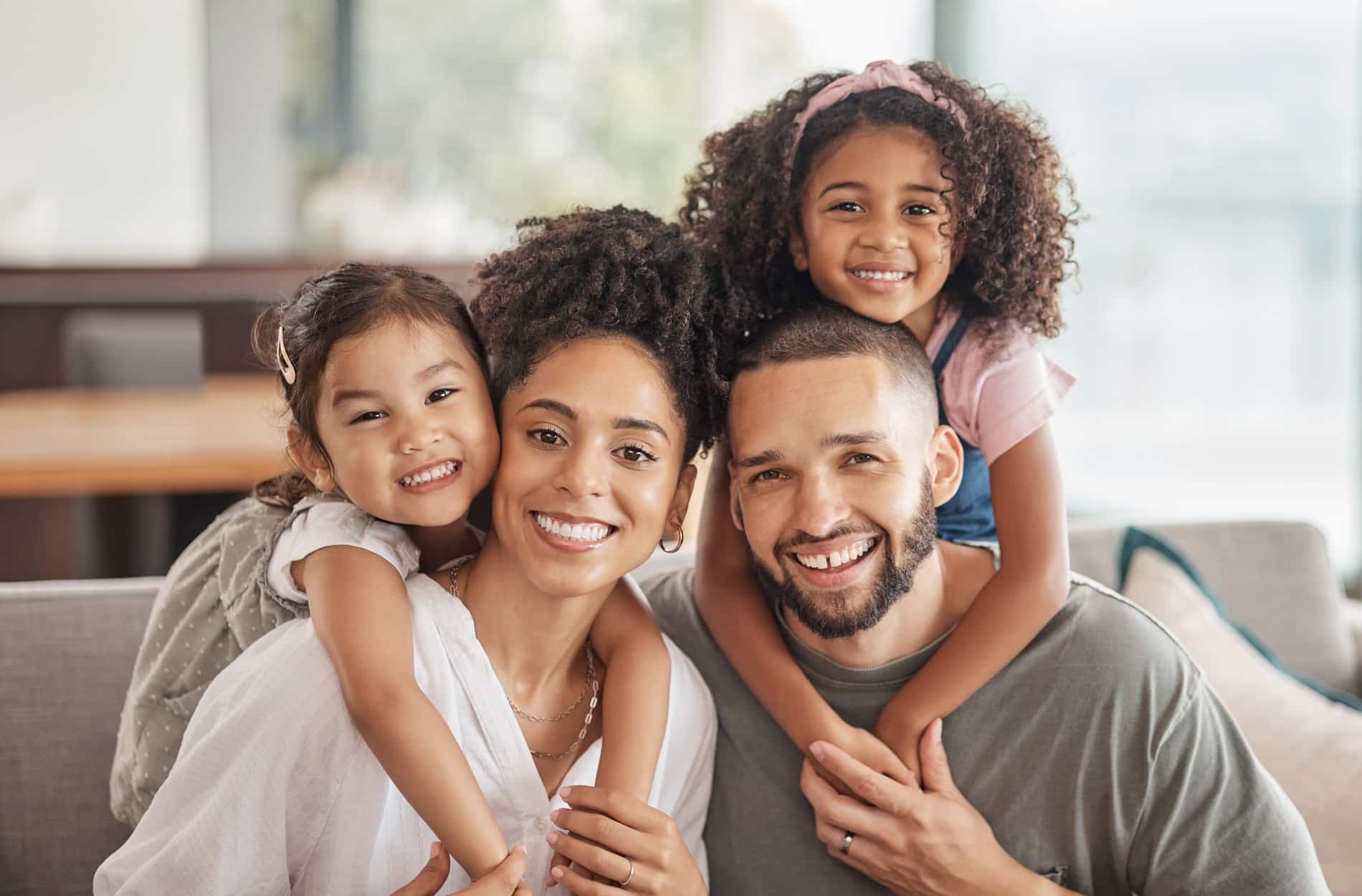 AdobeStock_536573741 v2 Family smiling after a pediatric dental appointment with Dr. Cholewa in Des Moines IA