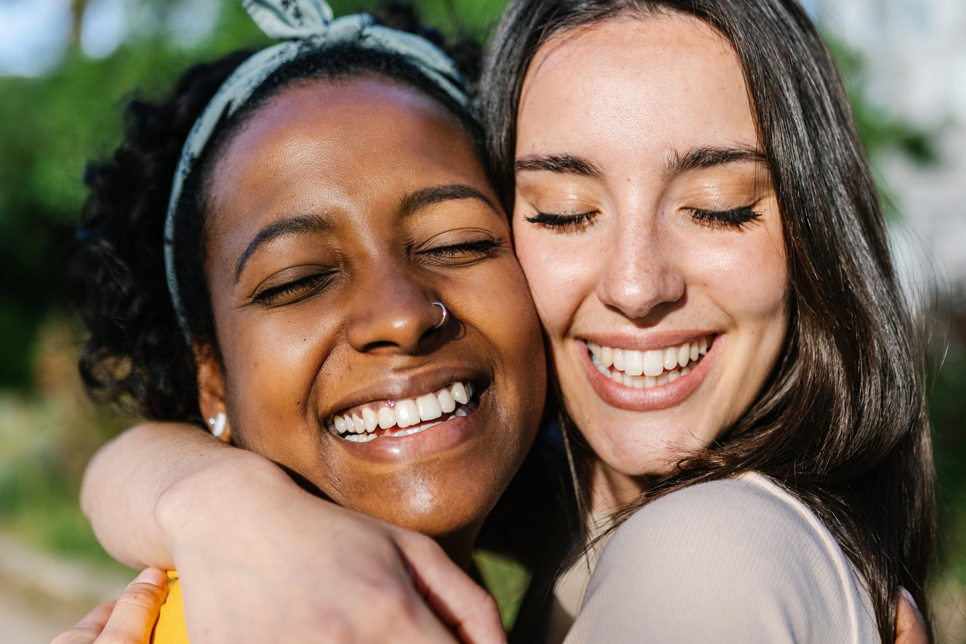 AdobeStock_513782440 v2 Women hugging with healthy teeth after a dental checkup in Des Moines IA