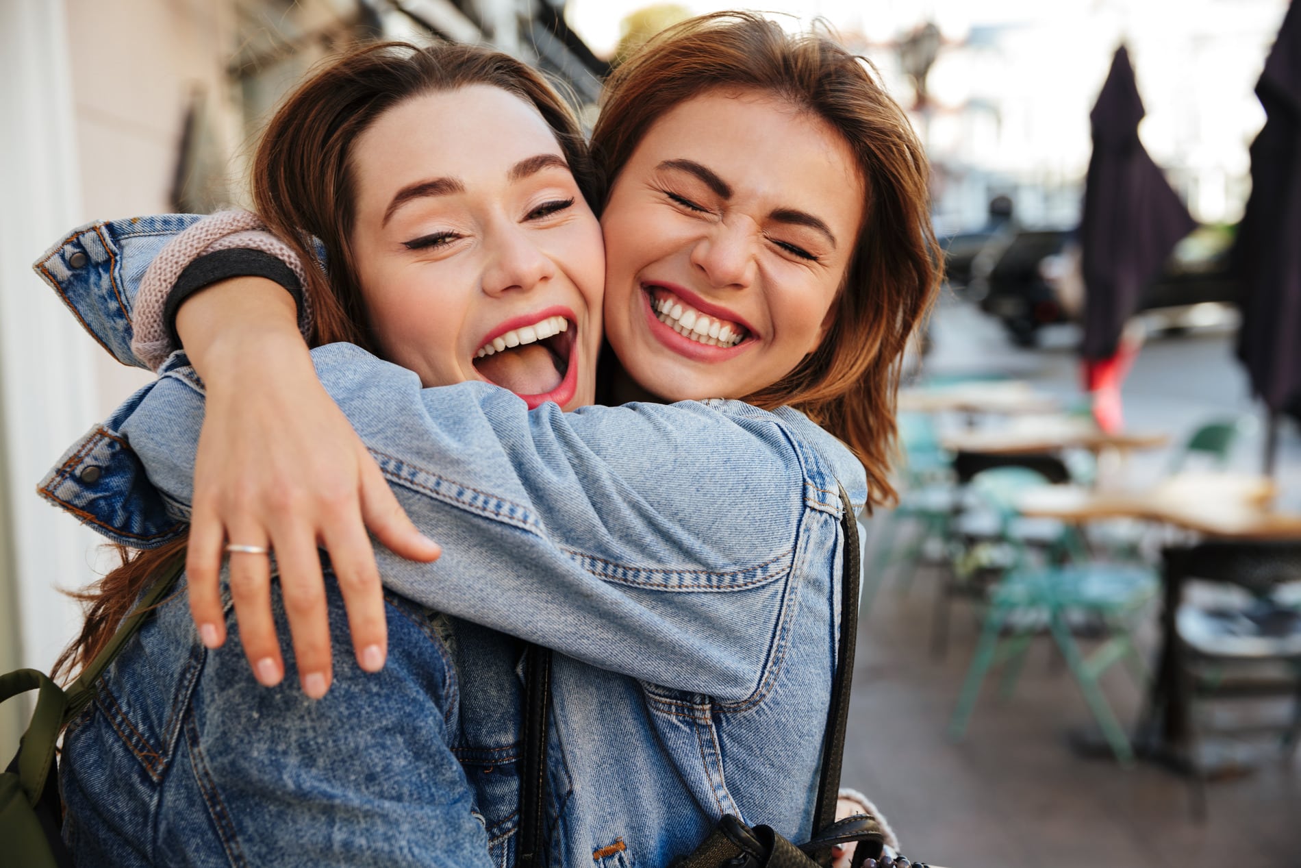AdobeStock_177155087 v2 Friends hugging and feeling good after a professional dental cleaning in Des Moines IA
