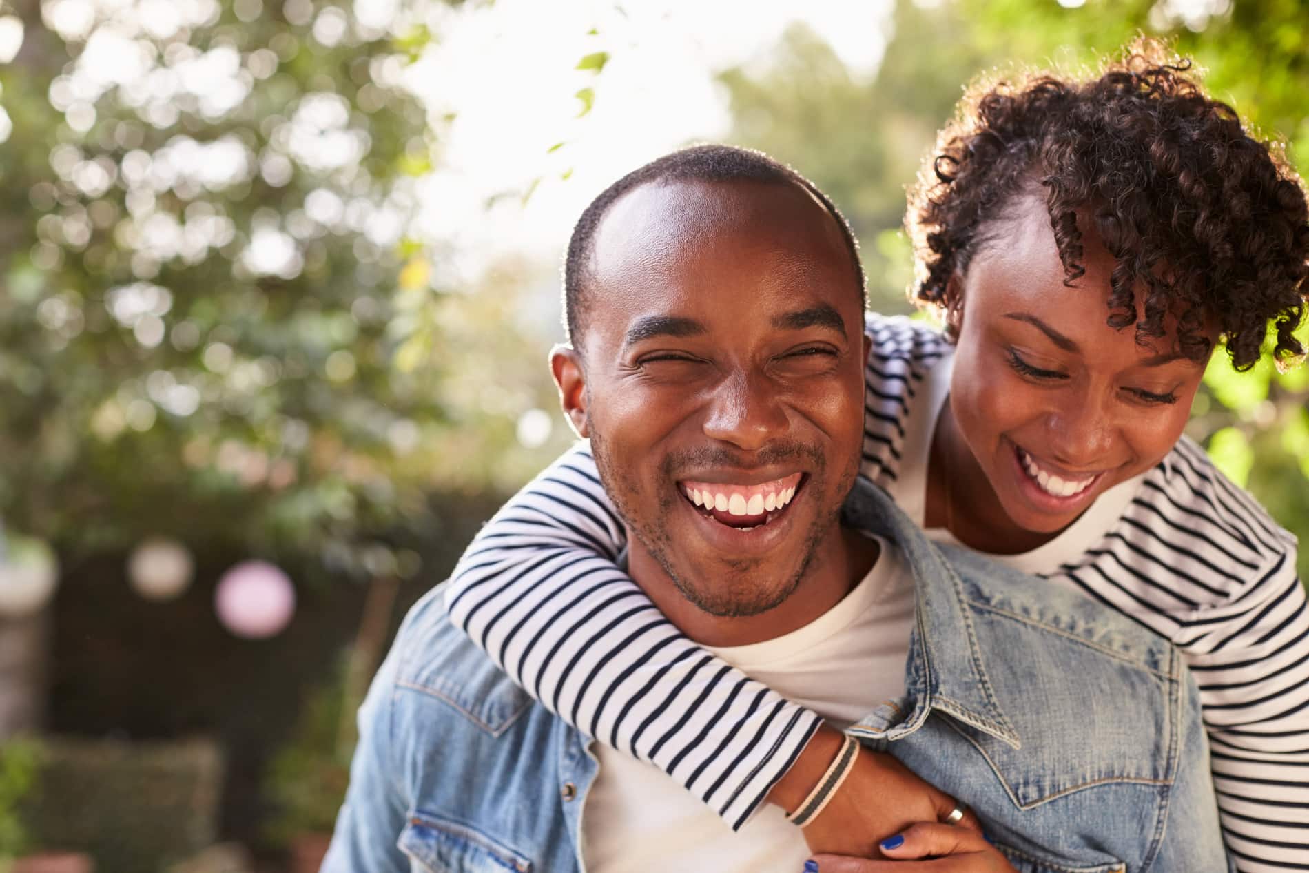 Couple smiling after dental extractions in Des Moines IA